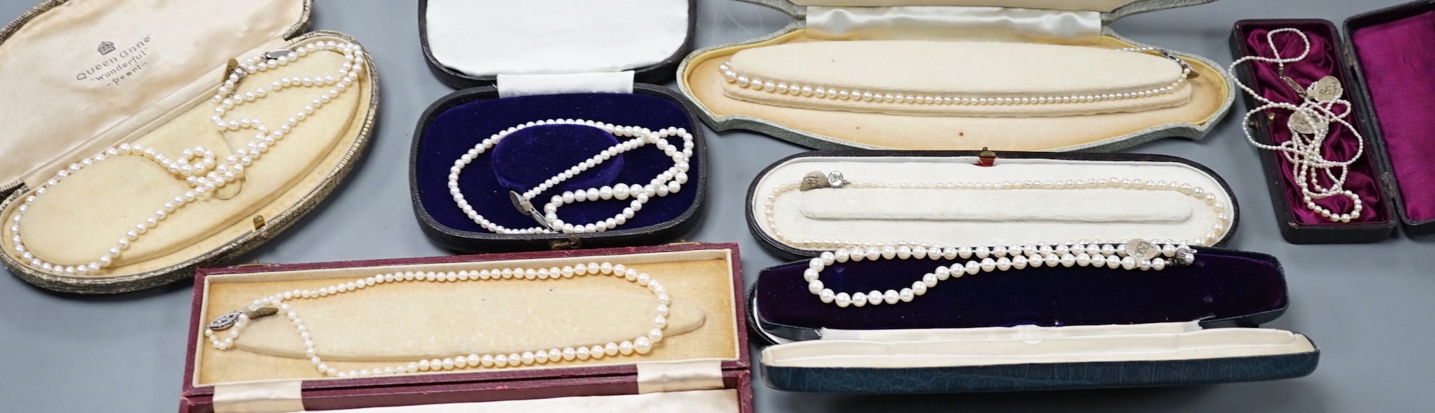Six assorted single strand graduated cultured pearl necklaces, with marcasite or paste set clasps, longest 64cm and two small seed pearl necklaces, one with rose cut diamond and seed pearl set clasp.